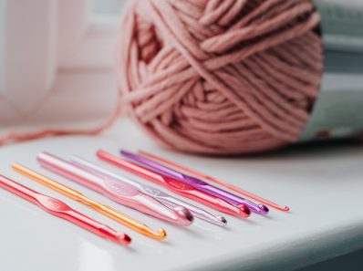 crochet needles and threads on windowsill
