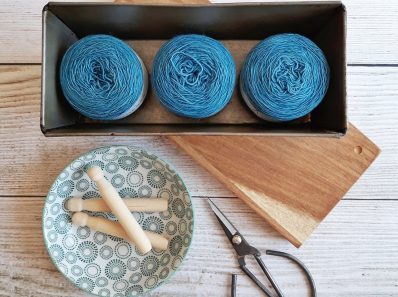 three blue yarn threads