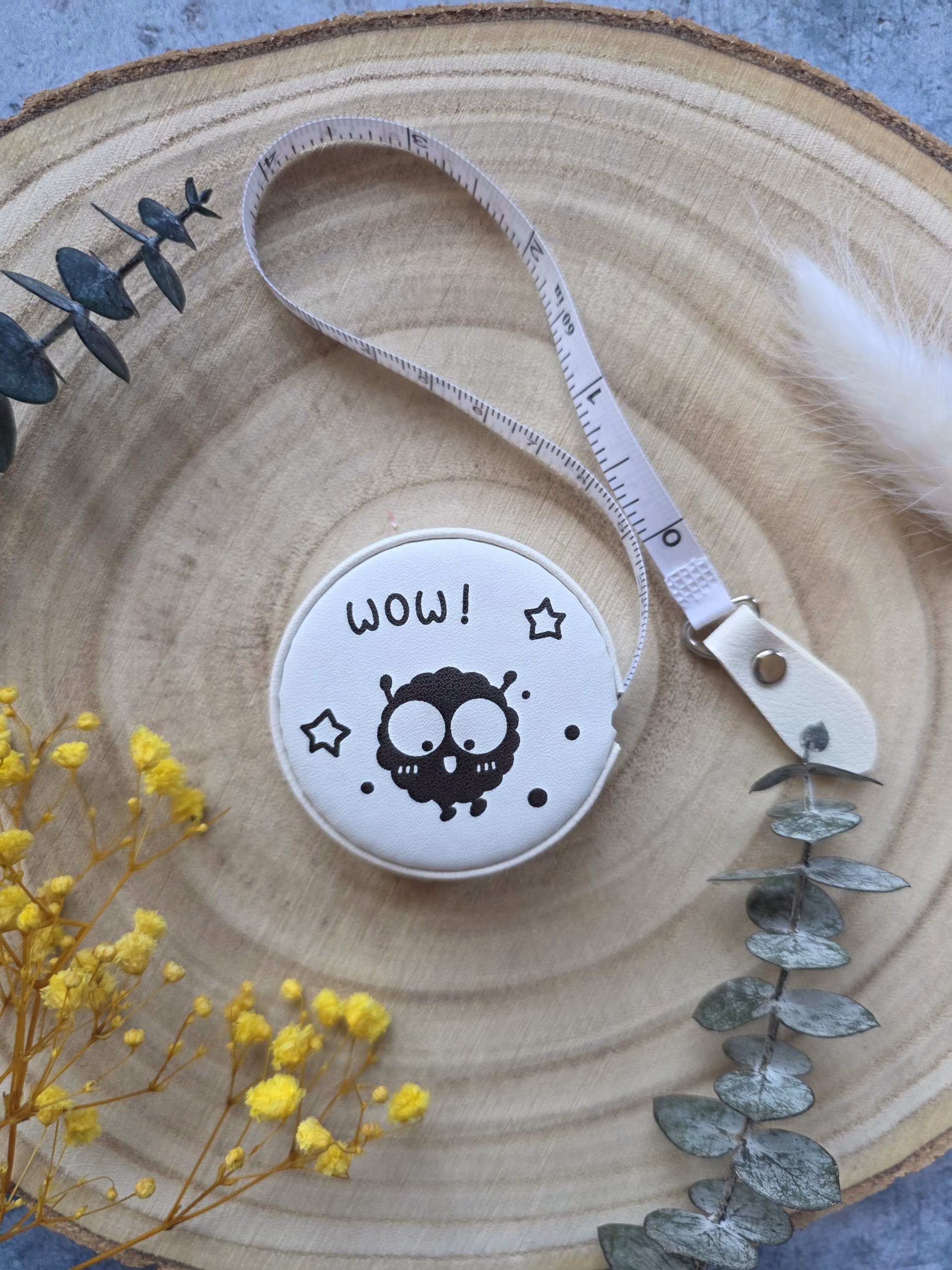 Le mètre ruban Boule de Suie allie mignonnerie et précision : rétractable, double graduation cm/pouces, petite créature noire kawaii. L'accessoire parfait pour tes projets !